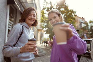 Two cheerful girls looking straight at camera