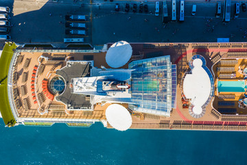 Large cruise ship docked at port . Top down aerial view