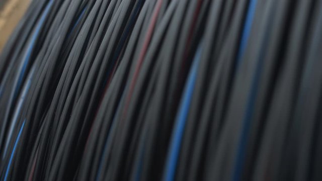 Close-up of a power cable on a big wooden spool. Finished products cable plant.