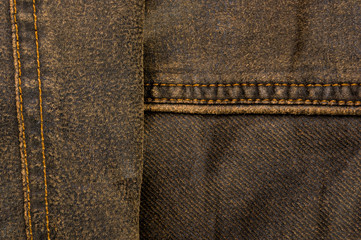clothing items stonewashed cotton fabric texture with seams, clasps, buttons and rivets, macro