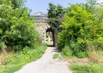Fototapeta premium a rural path underneath the railway next to Chatillon, Aosta Valley, Italy