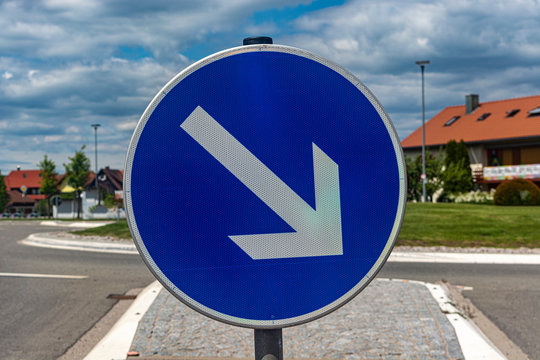 Road Round Blue Arrow Sign. Close Up. Blue Sky