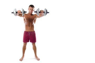 Fototapeta na wymiar Fitness and healthy lifestyle. Young attractive guy at the gym.
