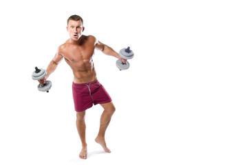 Young funny bodybuilder and dumbbells.