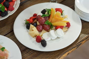 Raw fresh organic fruit and cheese plate