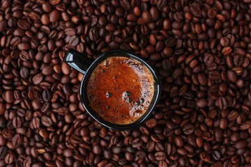 Delicious fresh coffee in a black mug