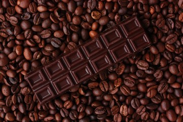 Delicious brown chocolate and coffee beans close up