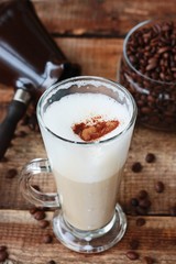 Roasted coffee beans and a cinnamon Dolce latte