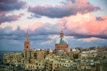 Naklejka premium Historical Valletta Skyline with sunset clouds