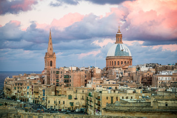 Fototapeta na wymiar Historical Valletta Skyline with sunset clouds