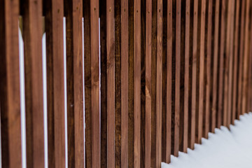 A picket fence covered with snow and the snow is still coming down.Winter wooden fence with snow. New Year's collection. Great for background for New Year and Christmas design.Wooden fence covered