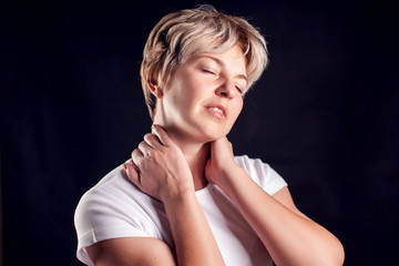 Fototapeta premium Woman feels neck pain. People, healthcare and medicine concept