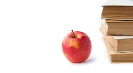 Heap of books with apple isolated on white background