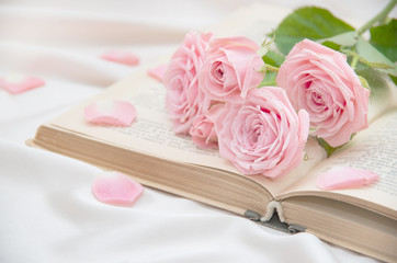 Roses and old book background