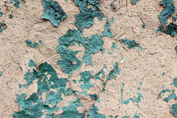 Texture of old peeled paint on old cracked stone wall