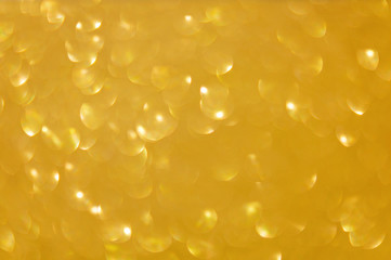 Holidays concept. Colorful defocused gold background with glittering and sparkling spots. Suitable for christmas, new year, chinese new year and designs