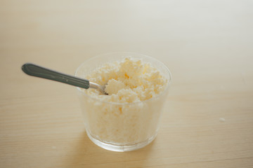 hand on spoon eating homemade grainy curd