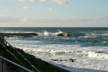 Heavy seas coming over a harbour wall in Cornwall