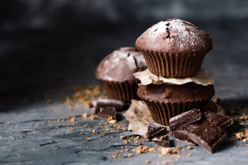 Sweet muffins with on dark textured background.