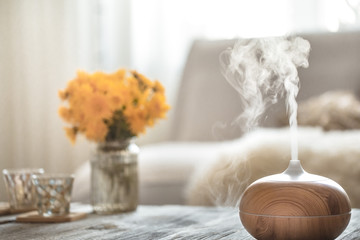 Humidifier on the table in the living room. - obrazy, fototapety, plakaty