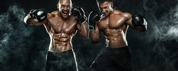 Two men boxers fighting in gloves on black background. Fitness and boxing concept. Individual...