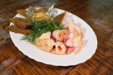 Dish of lard with croutons on a large old wooden table