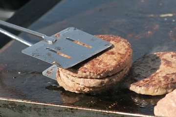 Flipping burgers on a grill 