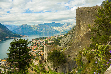 Fototapeta na wymiar Montenegro, Kotor, 09 October, 2019. View of Bas-relief (low relief) on old Kotor walls of the old town and ancient walls of Kotor Fort (St John Fortress) and Chapel of Our Lady of Salvation
