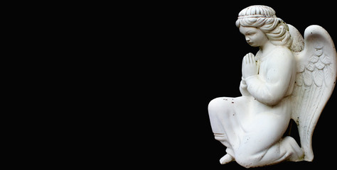 Little angel prays on his knees. Child death concept