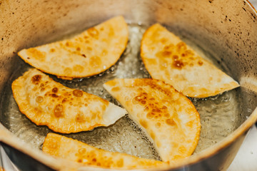 frying homemade pastries at home, brazilian cultural salty food