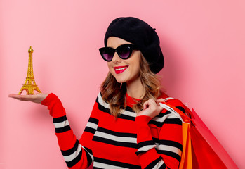 style woman in striped jumper with shopping bags and Eiffet tower.