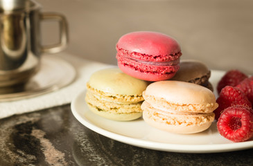  Closeup Macaroons dessert on the plate with blurred cap on the background