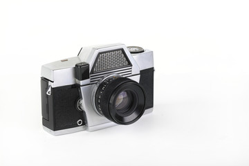 The old 35 mm film camera with lens, on white background.