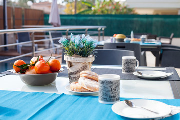 set table with oranges and croissants