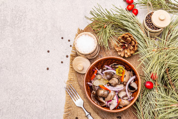 Obraz na płótnie Canvas Pickled (fermented) mushrooms. Traditional New Year (Christmas) snack. Festive table cutlery setting