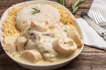 Homemade beef with bechamel, palm and cheese sauce on wooden background