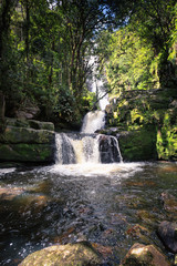 Obraz premium Small waterfall forming a natural pool in the middle of the forest in a river of Santander, Colombia.