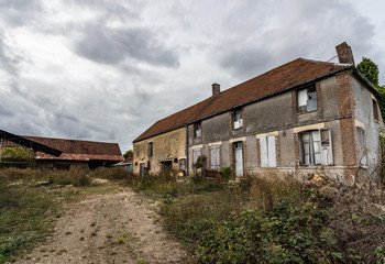 Fototapeta na wymiar An old abandoned and decaying farmhouse in the rural french countryside