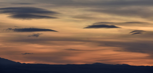 splendid autumn sunset with different types and colors of lenticular clouds