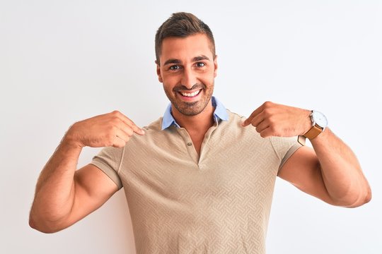 Young handsome man wearing elegant t-shirt over isolated background looking confident with smile on face, pointing oneself with fingers proud and happy.