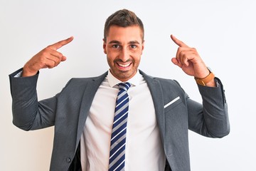 Young handsome business man wearing suit and tie over isolated background smiling pointing to head with both hands finger, great idea or thought, good memory