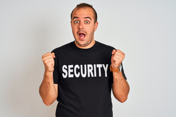 Young safeguard man wearing security uniform standing over isolated white background screaming proud and celebrating victory and success very excited, cheering emotion