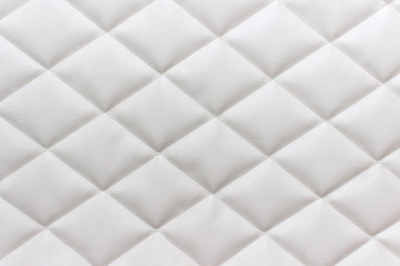 White fabric tufting cloth texture with diagonal stitches. Sewing background.