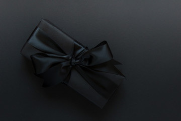 Present with black bow on black backgound