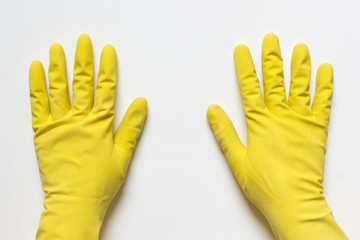 Left and right hands in yellow rubber washing gloves isolated on white background.