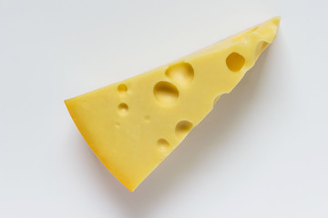 Large piece of Maasdam cheese with large pores holes on white background.