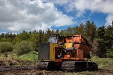 Fototapeta na wymiar Heavy machinery used for cultivating peat bog in the Irish countryside