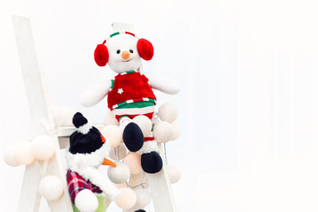 Funny toy of the snowman in the white background.