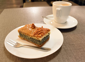 Pie with poppy and nuts. Cup of coffee