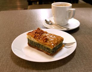 Pie with poppy and nuts. Cup of coffee